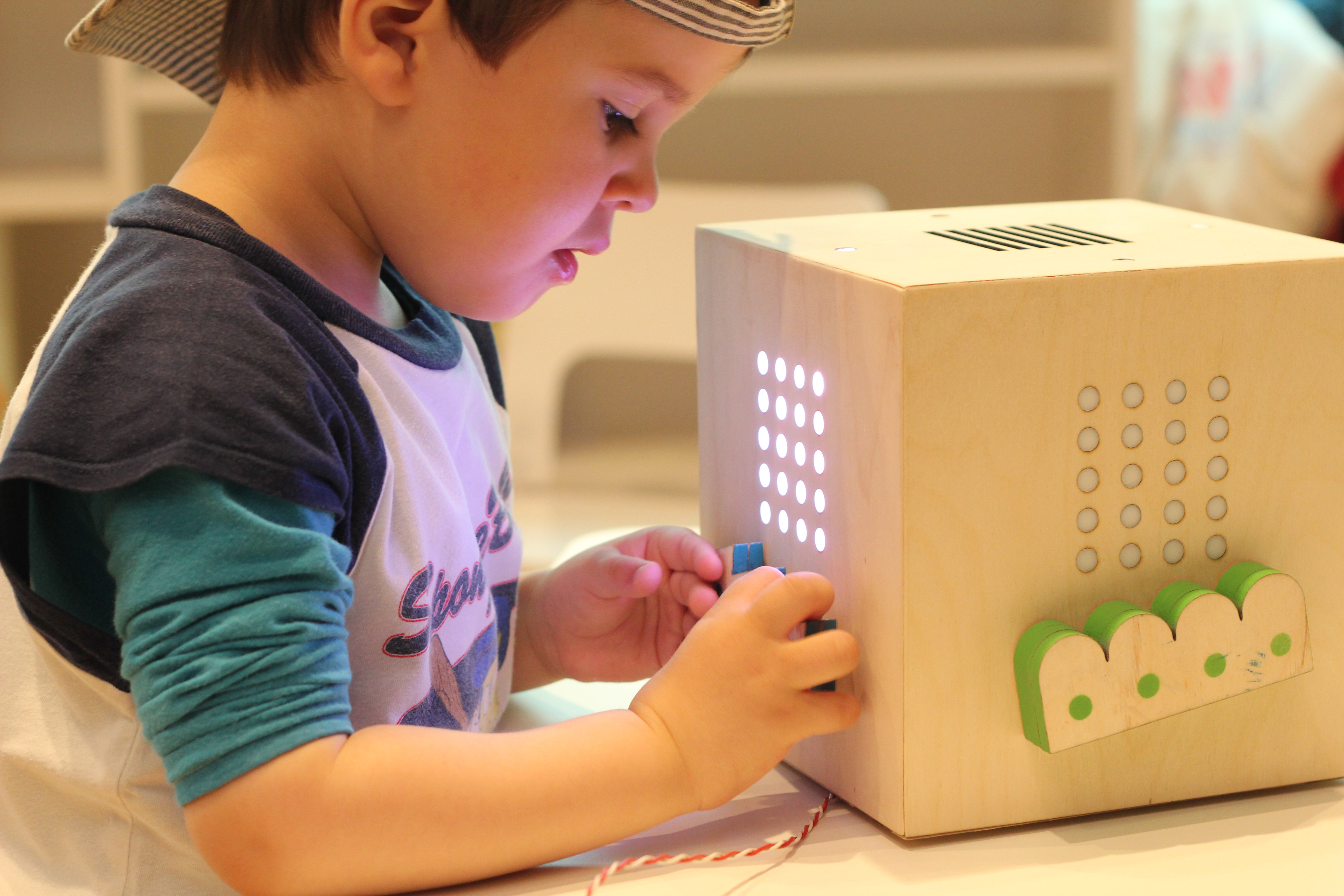Kid touching, watching and listening to his block